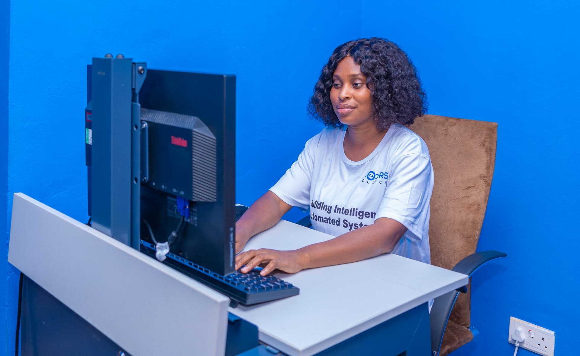 Team member working at a desktop computer in the Coders Clutch office