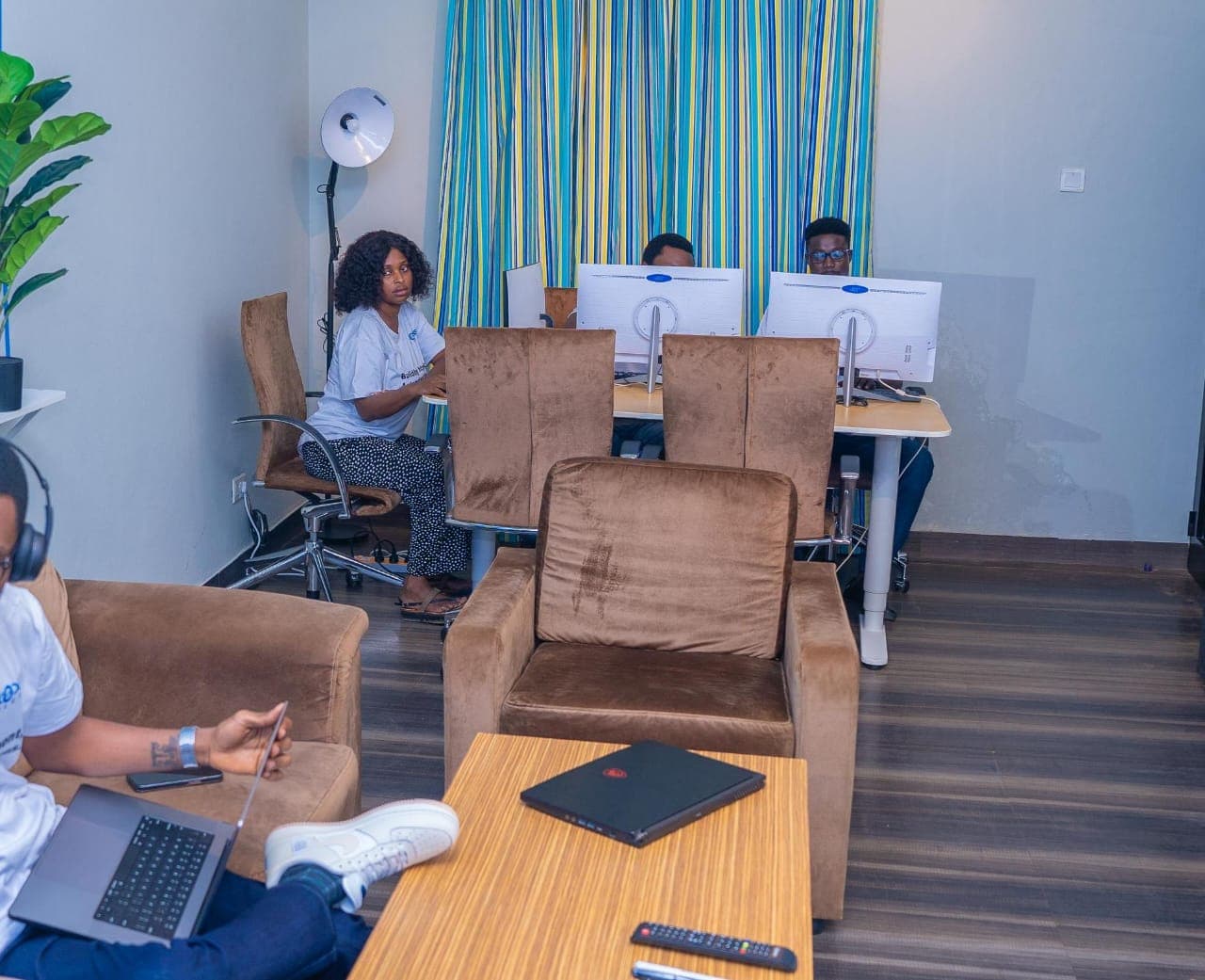 Office lounge with team members working at desks behind