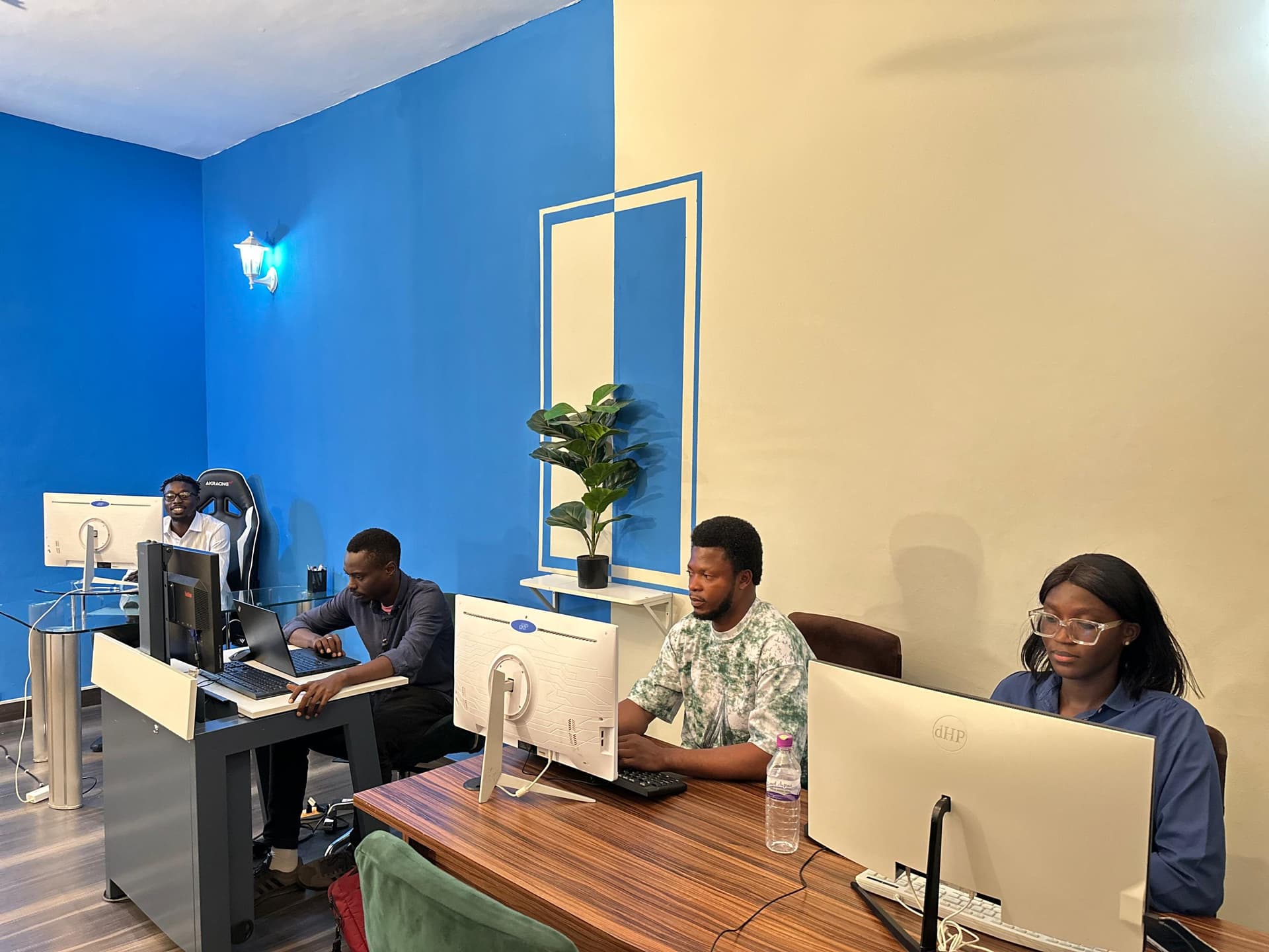 Team members working at desktop computers in the open-plan office