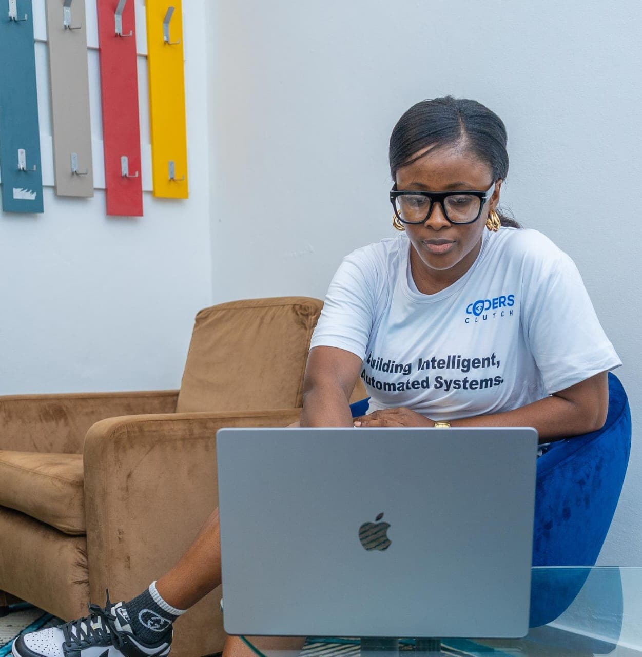 Team member working on a laptop in the office lounge