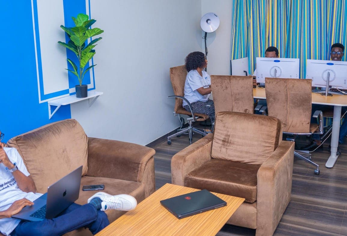 Coders Clutch office lounge with team members working at desks behind