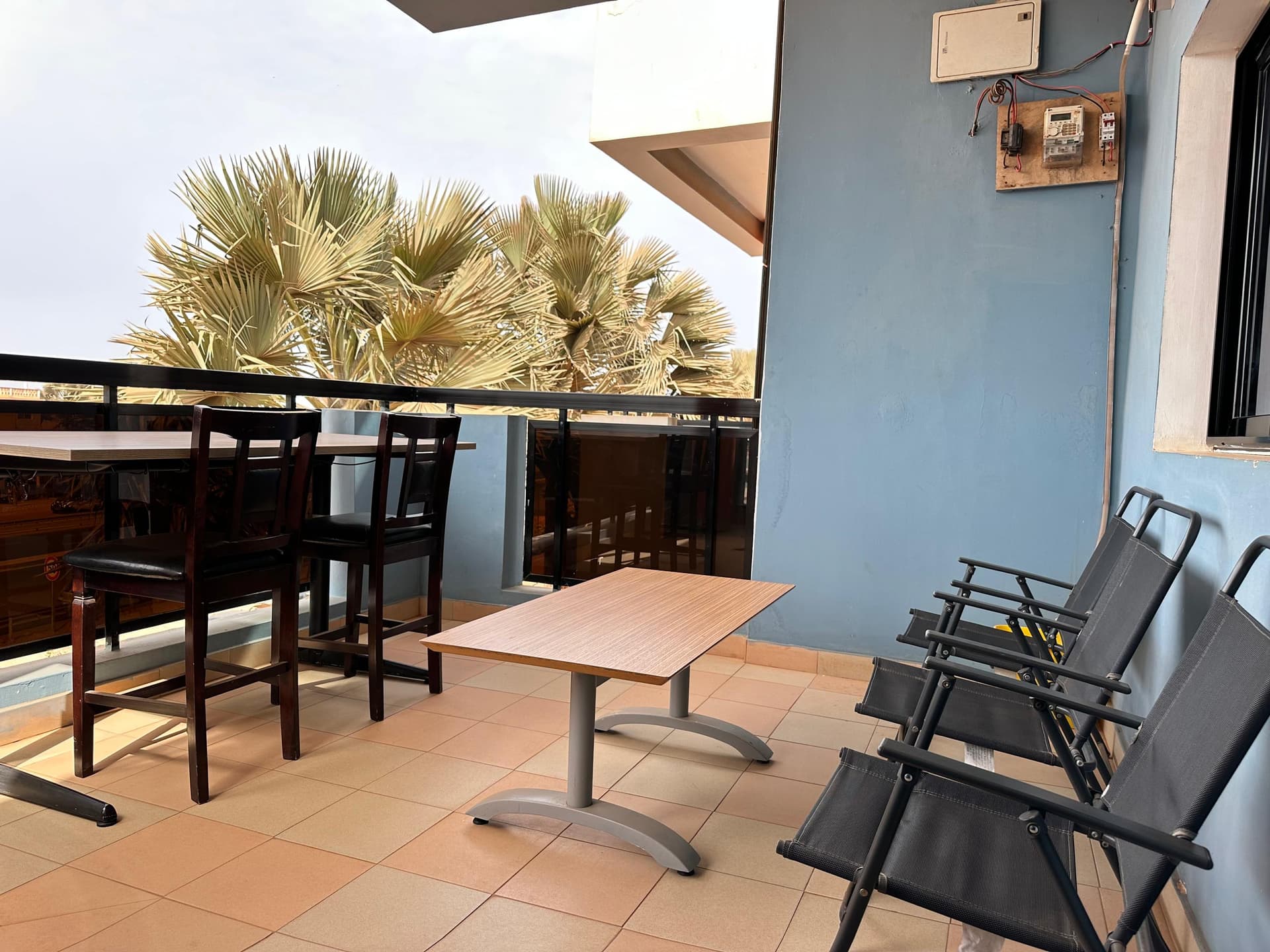 Office balcony with outdoor seating and palm trees
