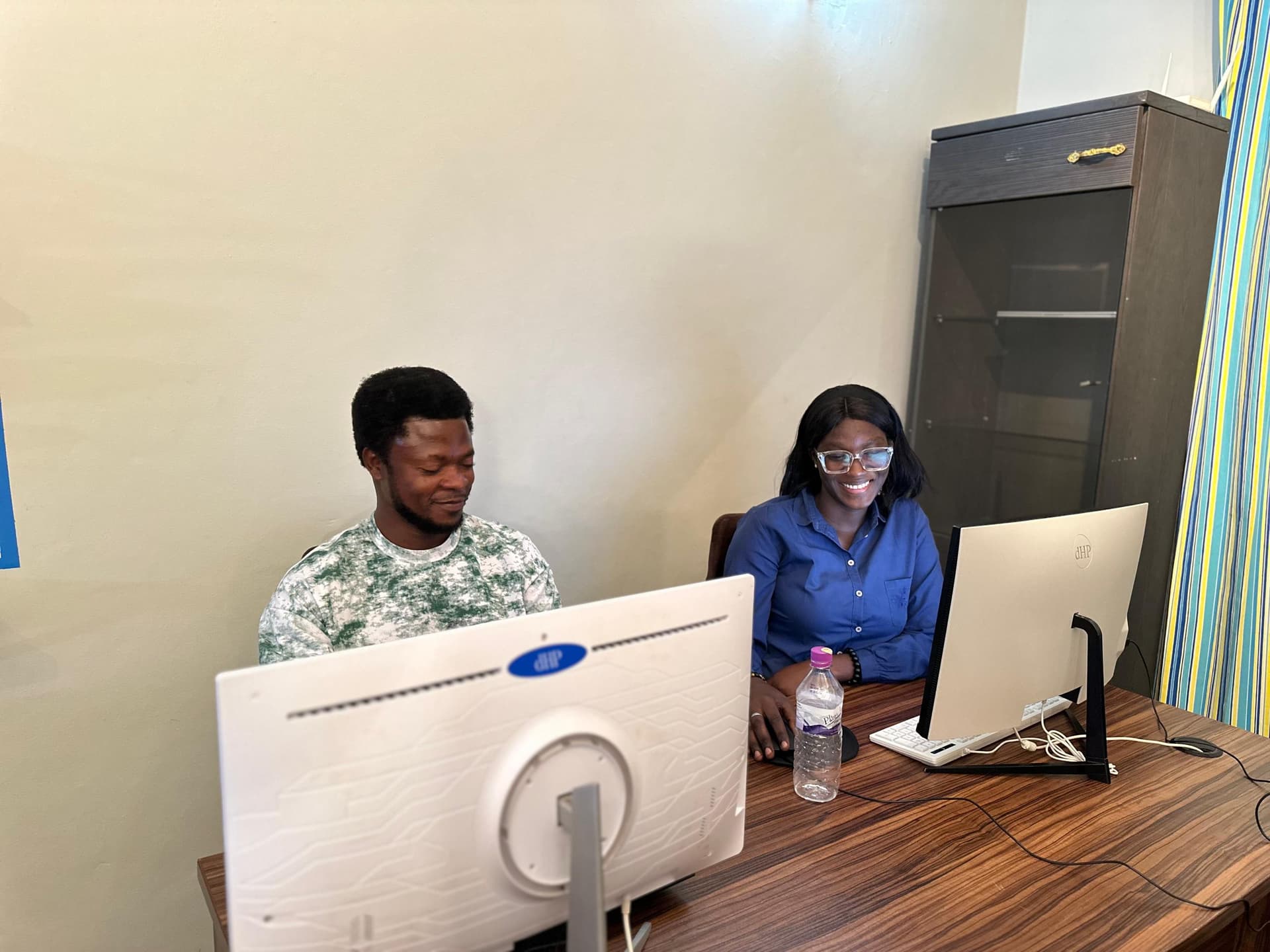 Two colleagues working at desktop computers
