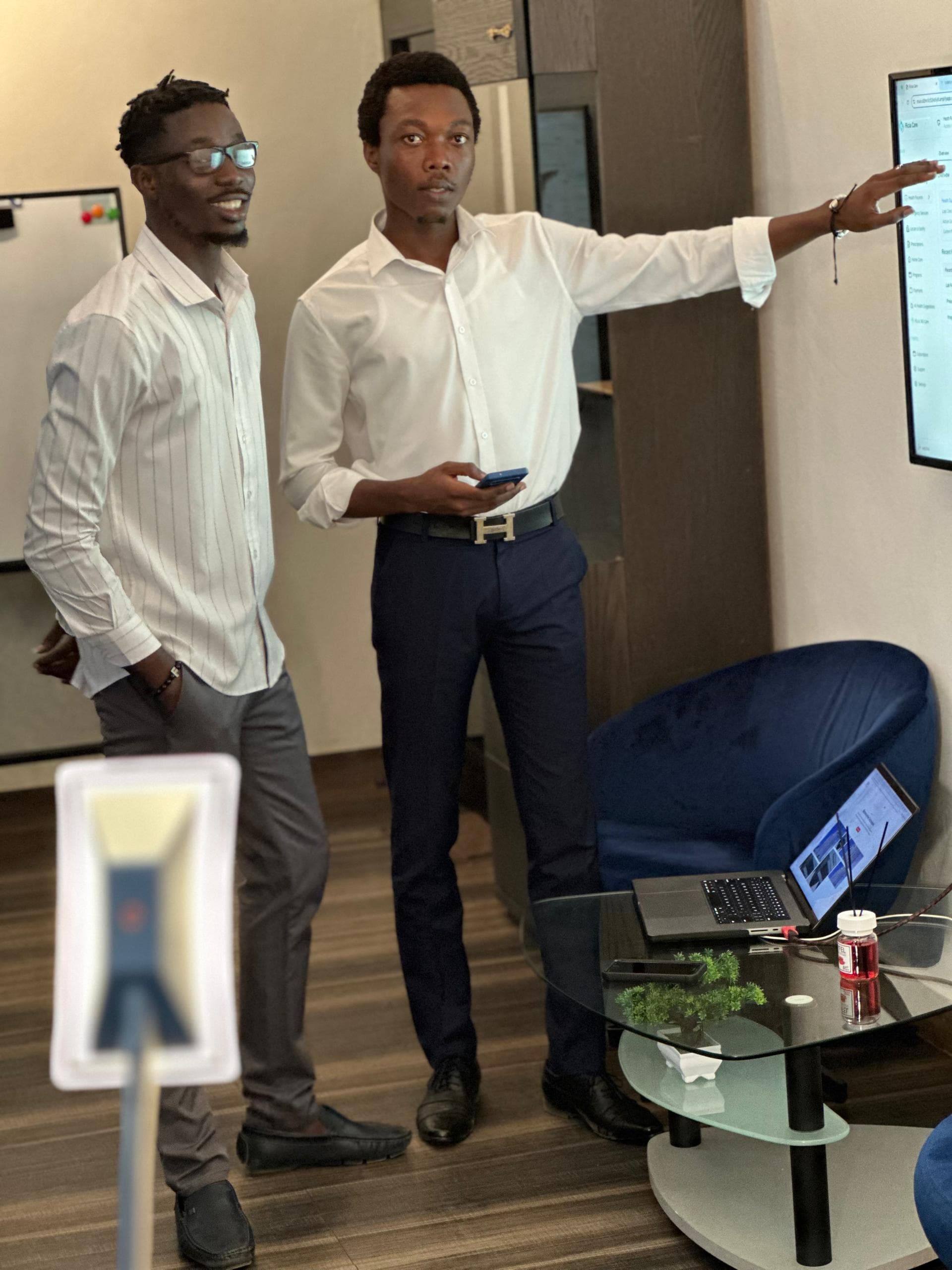 Colleague pointing at a wall screen during a discussion