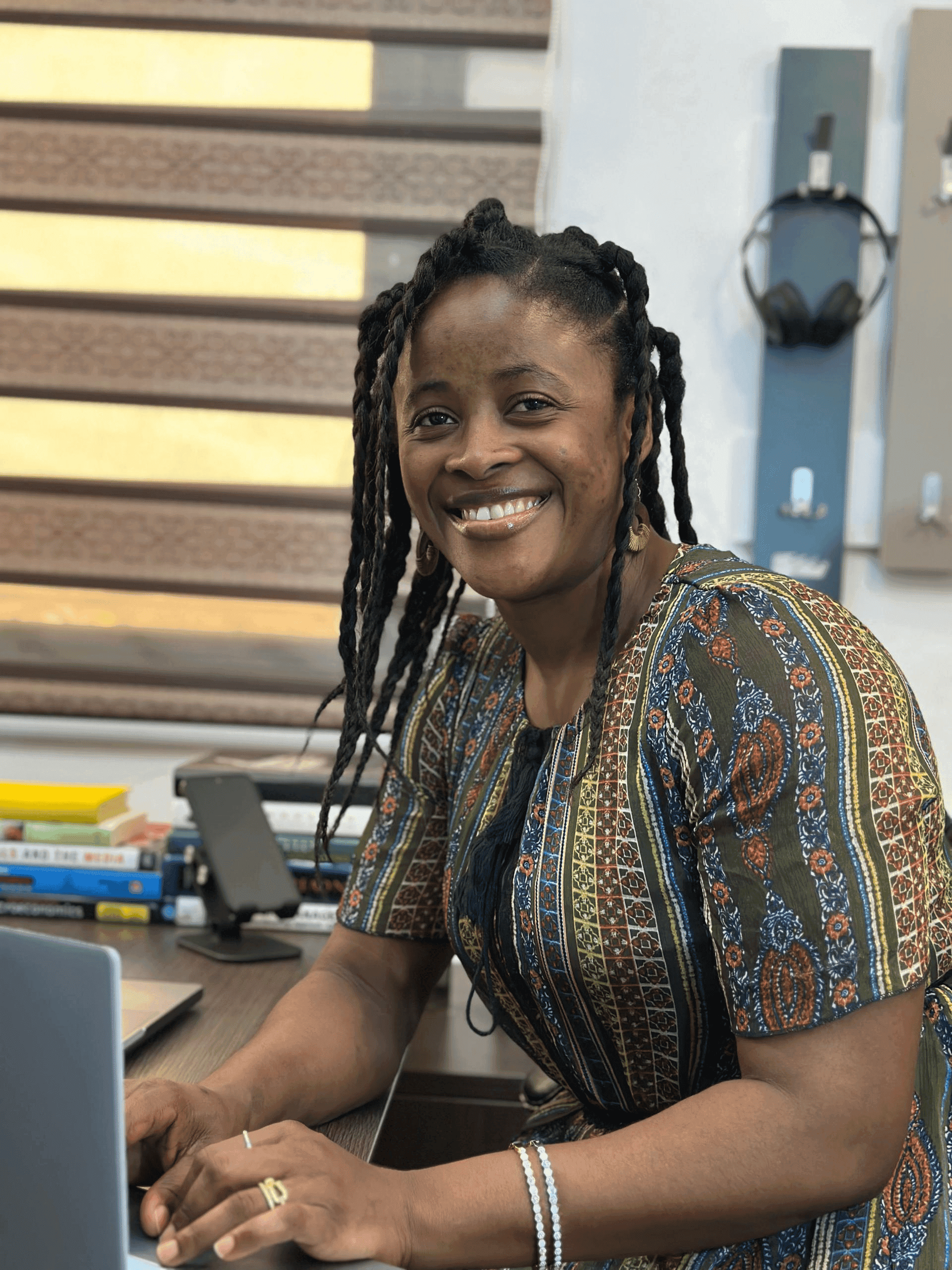 Team member smiling at her desk