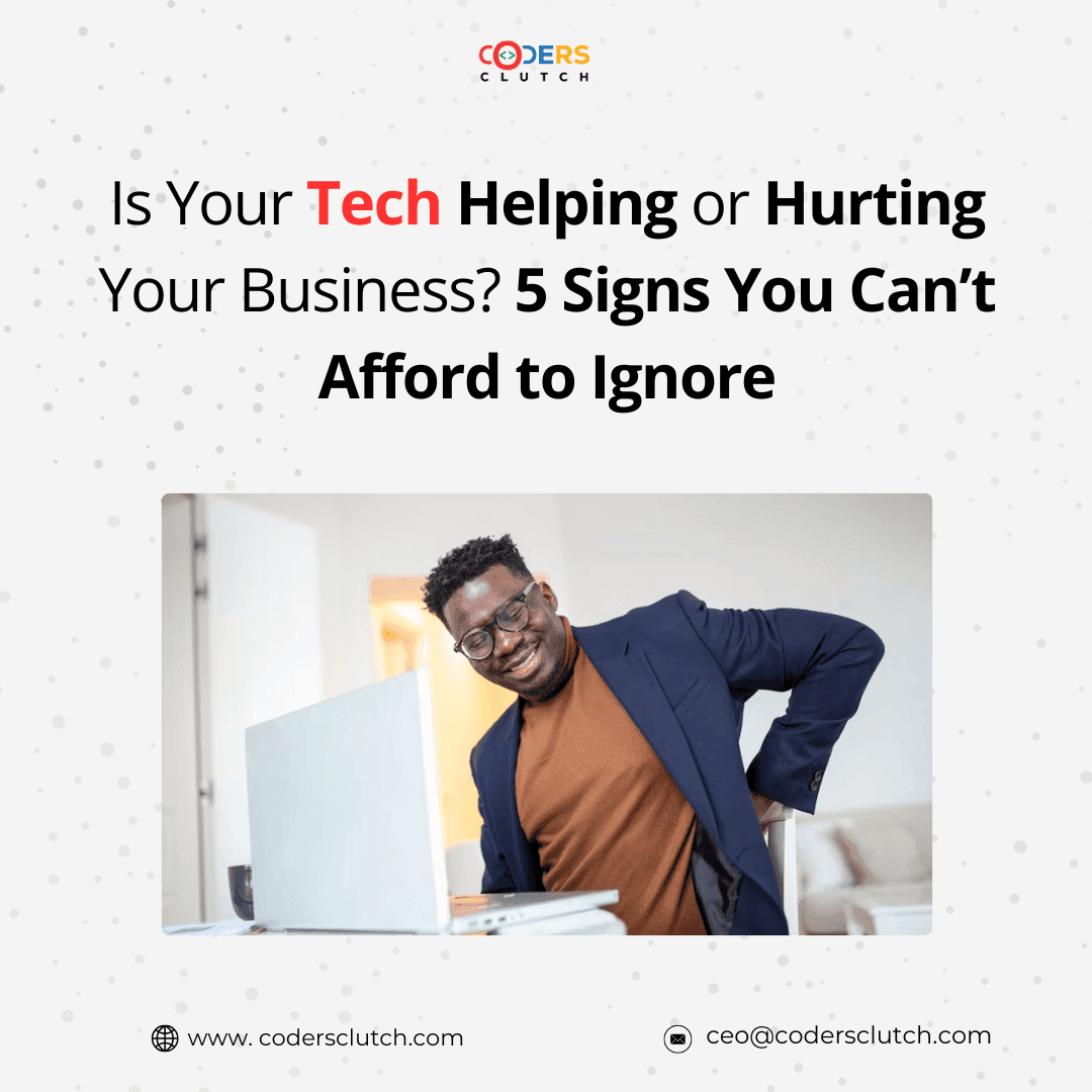 A businessman at his desk holding his aching back.