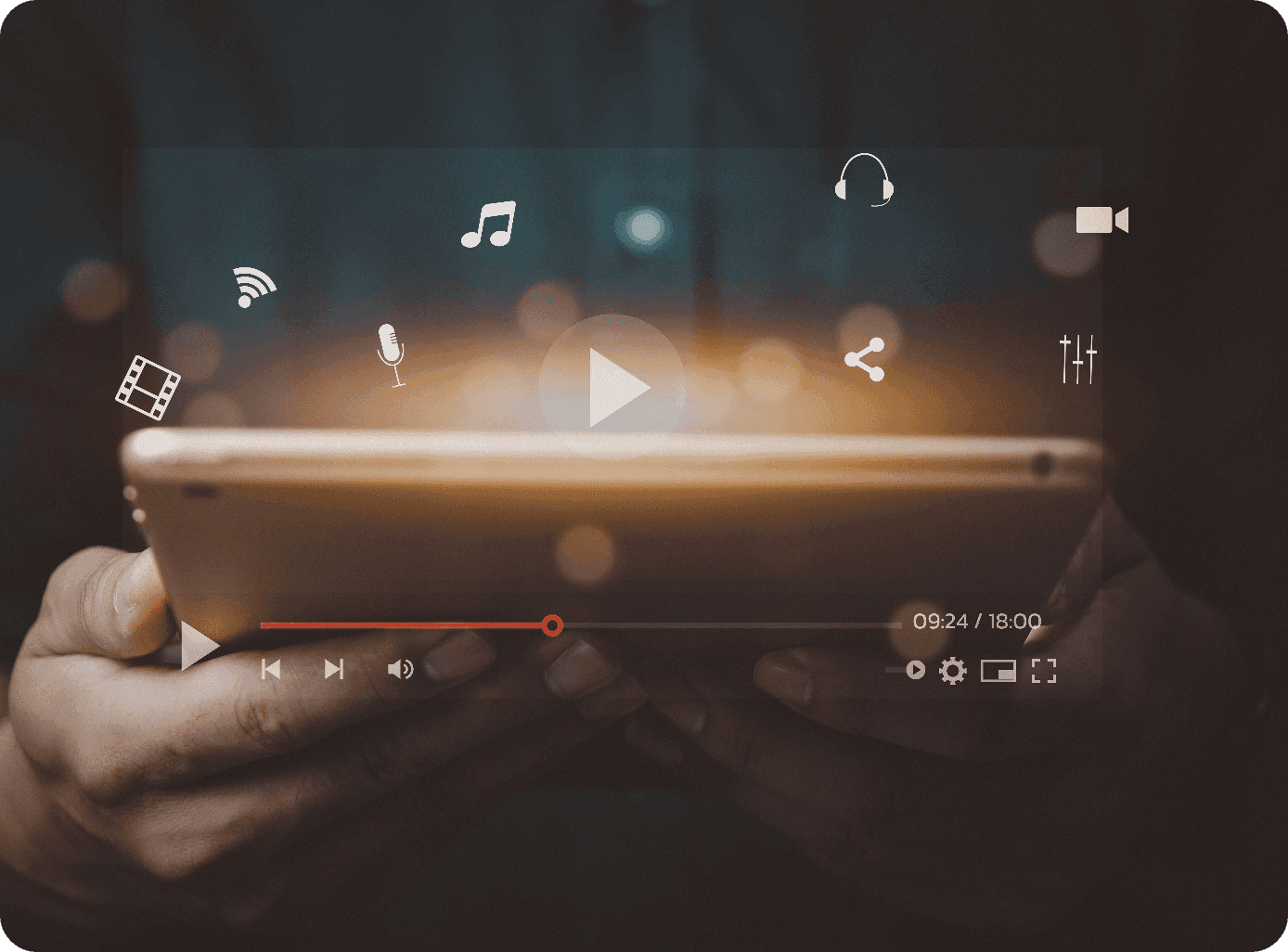 Hand holding a tablet playing a video with media icons