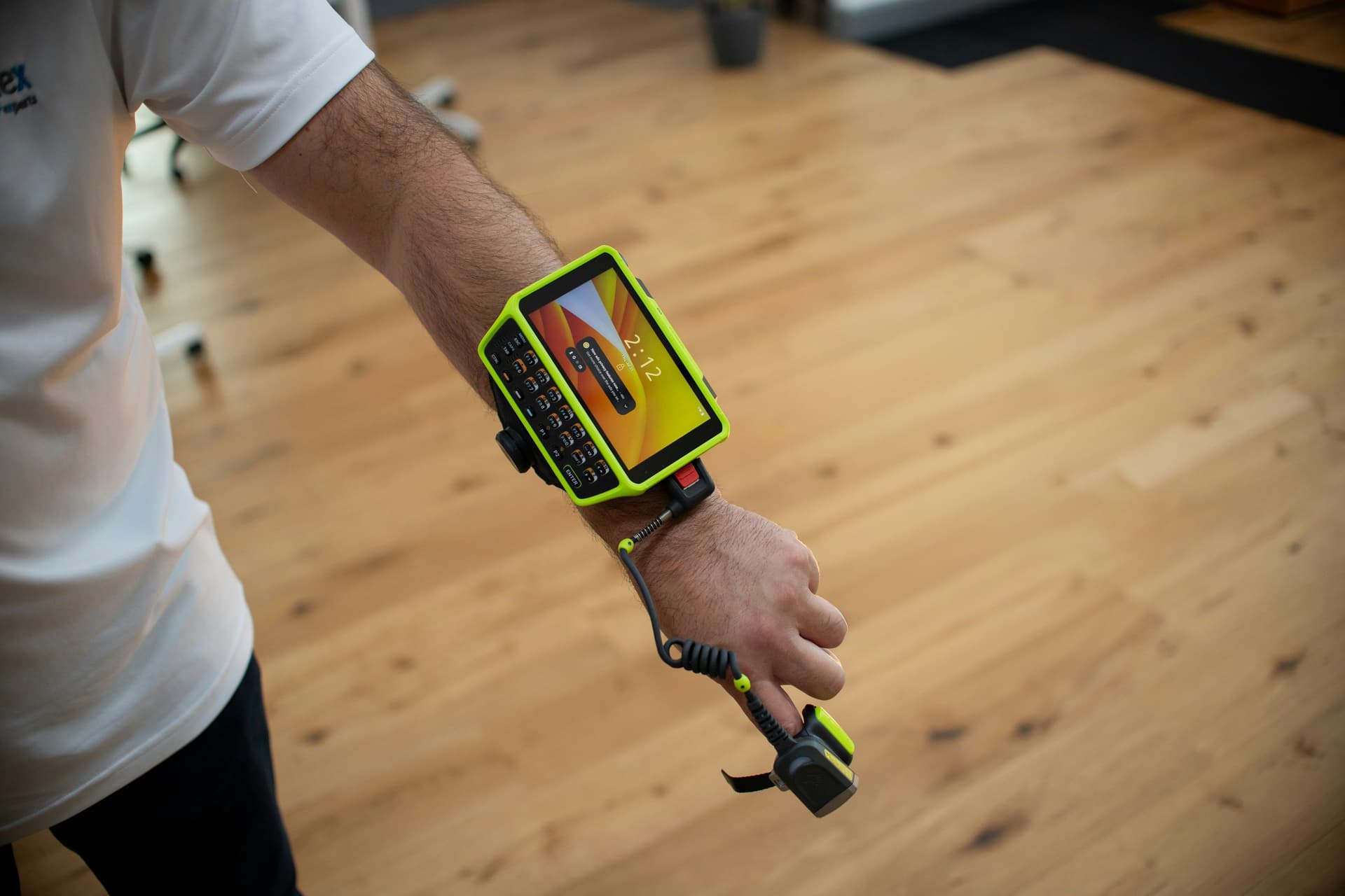Worker wearing a wrist-mounted barcode scanner